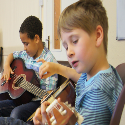 Xavier & Ethan children playing guitar